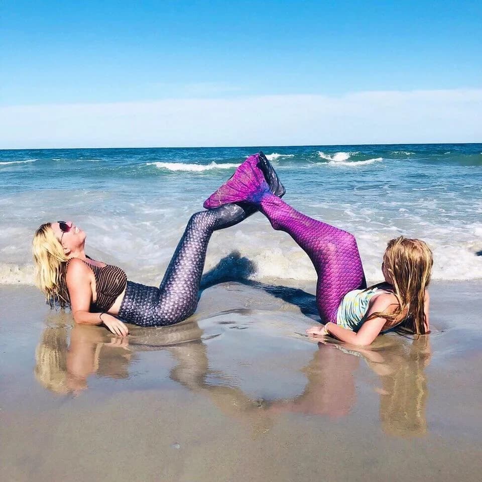 Molly in a mermaid tail on the beach