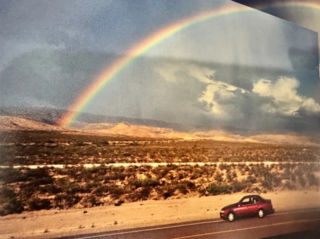 A rainbow over the desert road during the cross-country trip